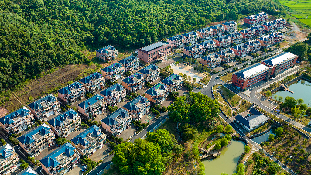The new homes of relocated villagers are nestled among lush green hills and trees, Xinyu City, east China's Jiangxi Province, August 17, 2022. /VCG
