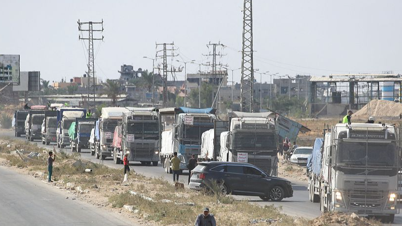Trucks carrying aid provided by the World Food Program drive on a road in Deir el-Balah after entering through the Kerem Shalom crossing in the southern Gaza Strip, October 17, 2025. /VCG