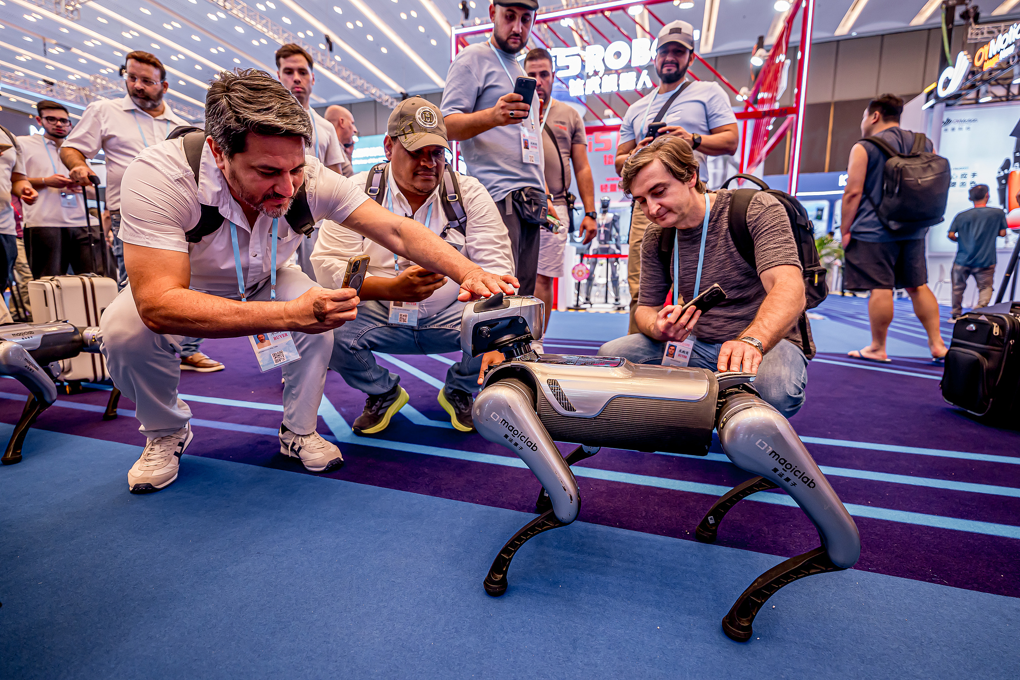 People take photos of a robot dog at the 138th edition of the China Import and Export Fair in Guangzhou, south China's Guangdong Province, October 15, 2025. /VCG