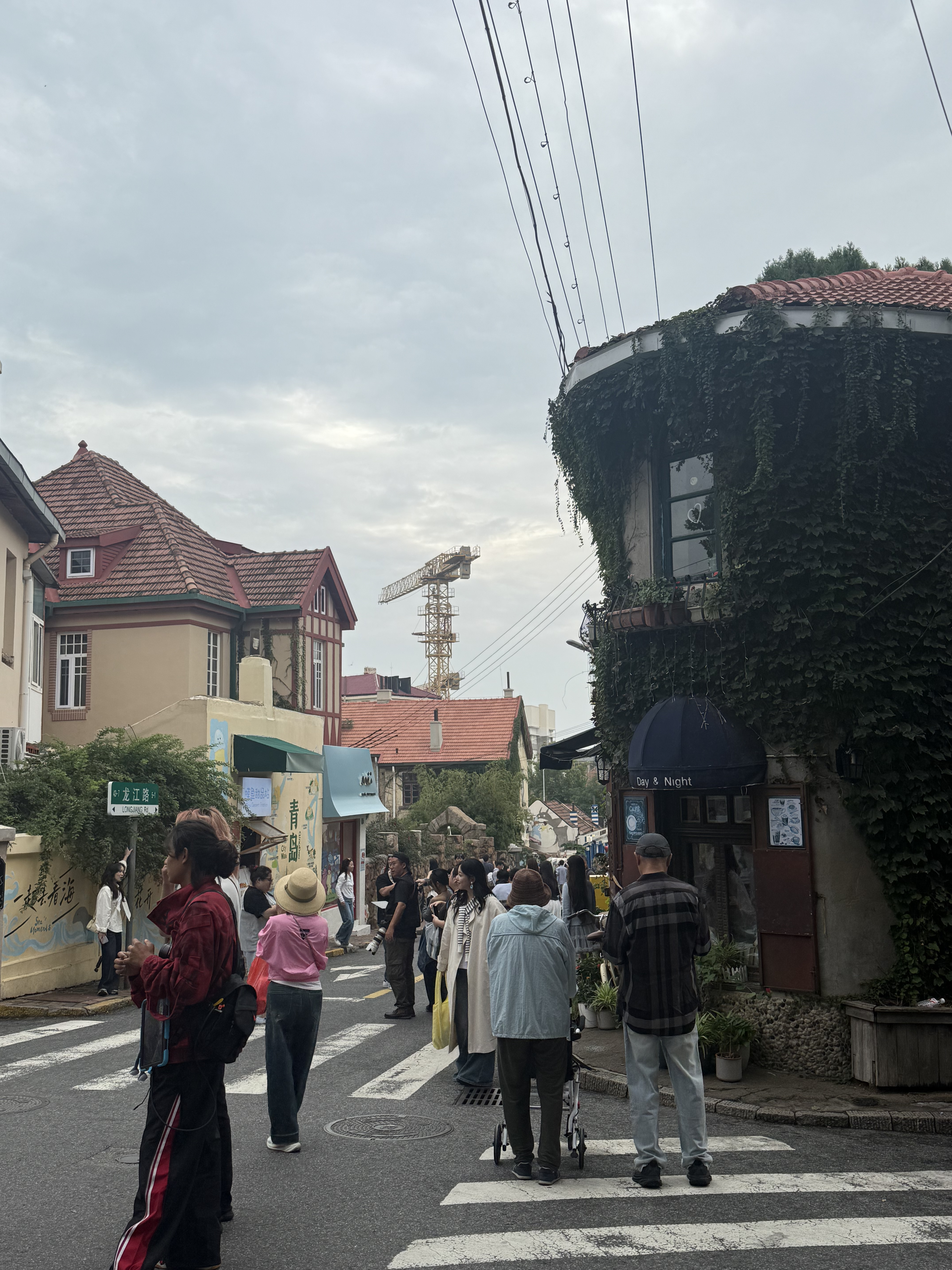 Visitors taking pictures on Qingdao University Road Anime Wall, Qingdao, September 2025. Zaruhi Poghosyan/ CGTN