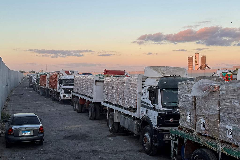 Trucks loaded with humanitarian aid on the Egyptian side of the Rafah crossing wait to cross into the Gaza Strip early on October 15, 2025. /VCG