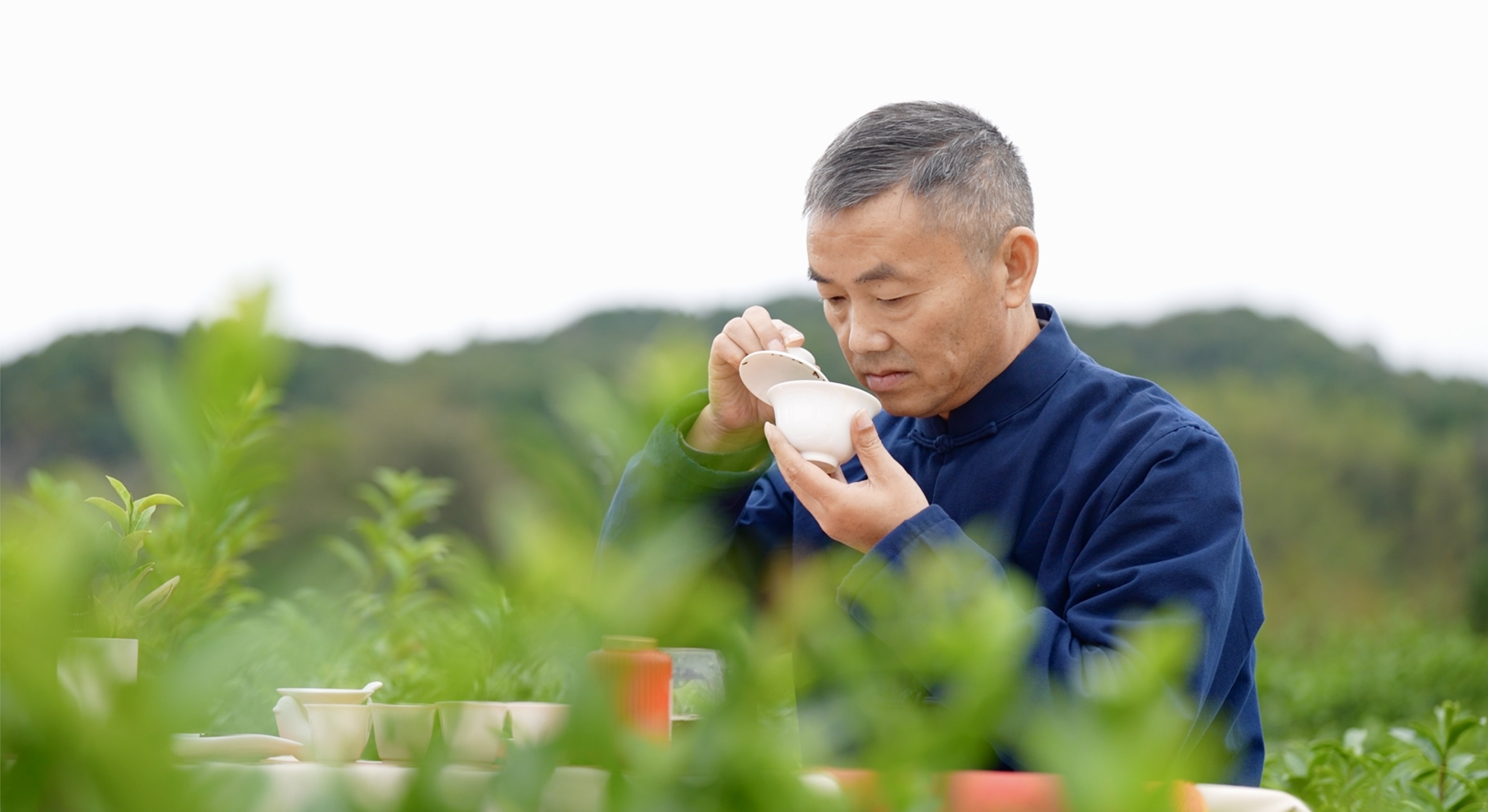 Ren Zhongzi, an inheritor of Keemun black tea, inhales the rich fragrance of the Keemun black tea, Qimen, Anhui Province, China. /CGTN