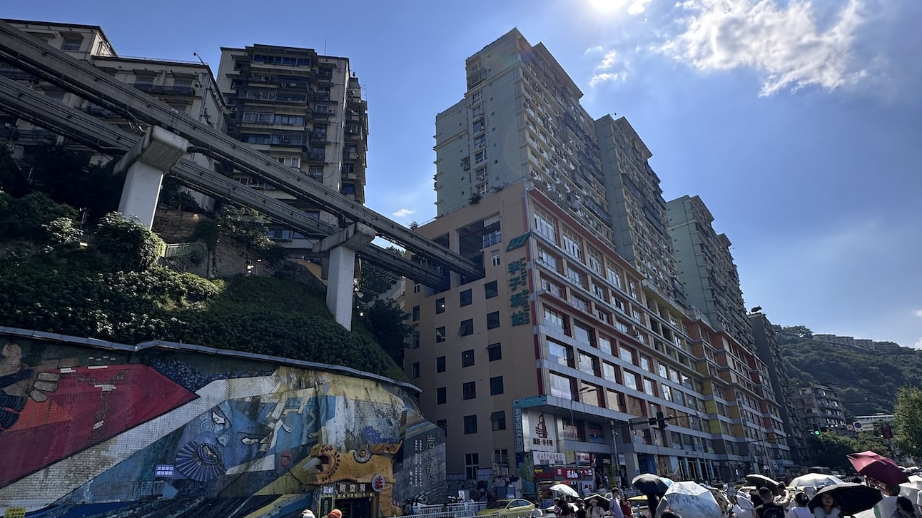 A view of the Liziba monorail station with the tracks emerging from inside a residential building in Chongqing, October 10, 2025. /Ankit Prasad