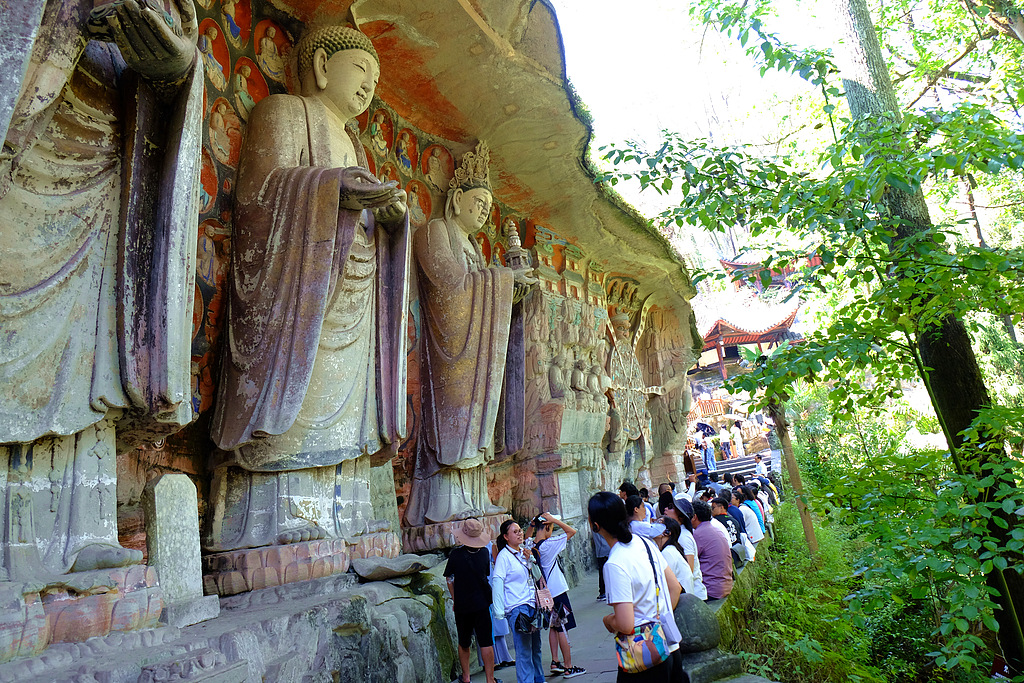 A file photo shows tourists at the Dazu Rock Carvings World Heritage Site in Chongqing. /VCG