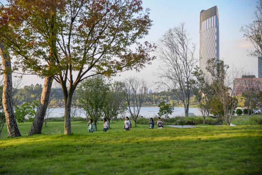 People walk by the side of Xinglong Lake in Tianfu New Area, Sichuan Province, October 17, 2024. /Xinhua