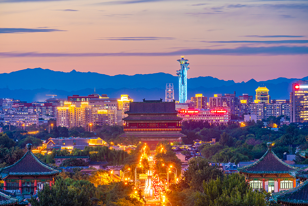 A file photo from 2024 captures the moment when Beijing's Central Axis lights up at dusk. /VCG