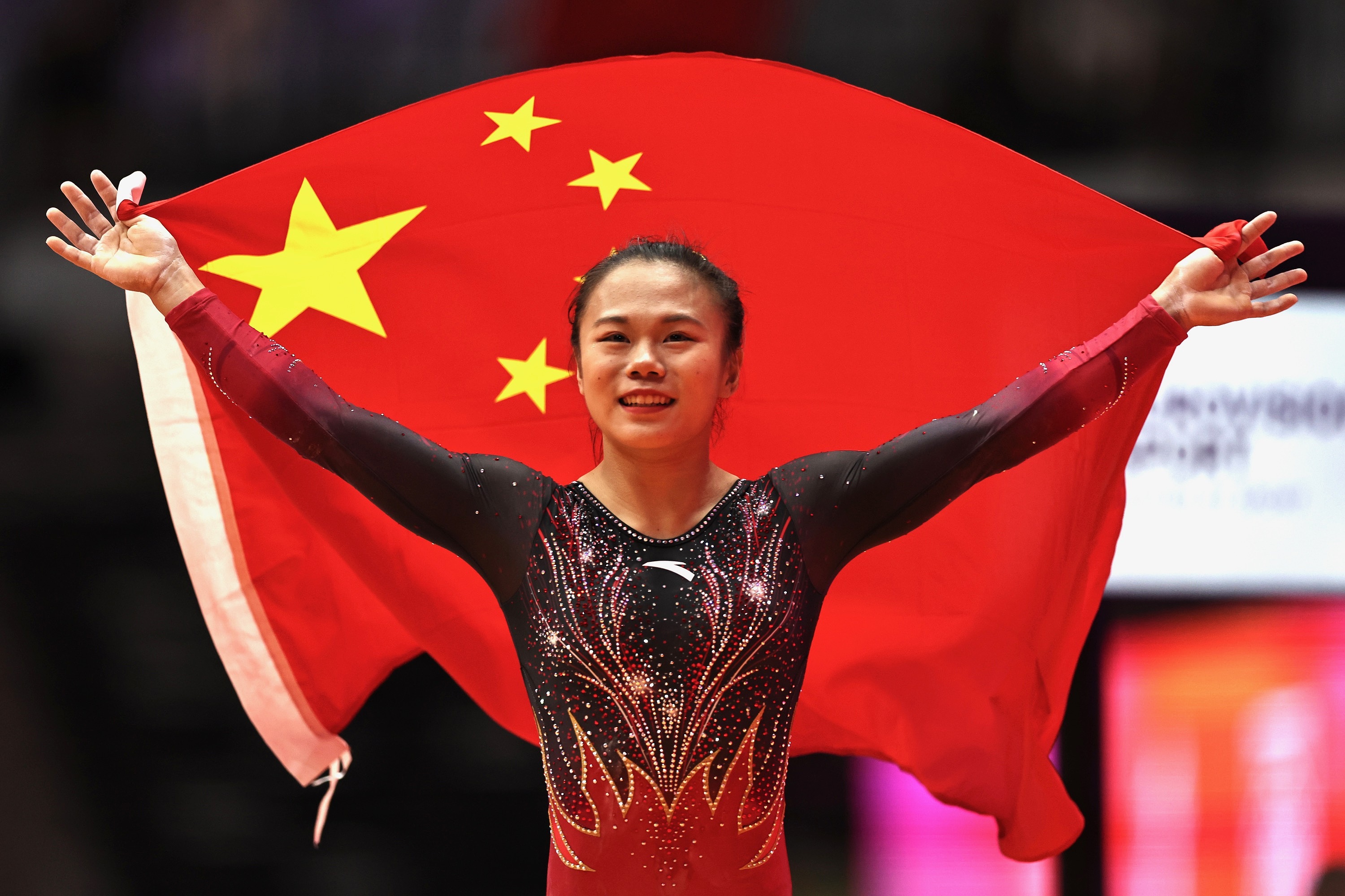China's Zhang Qingying holds the national flag after winning the women's balance beam final at the 53rd FIG Artistic Gymnastics World Championships in Jakarta, Indonesia, Oct. 25, 2025. /VCG
