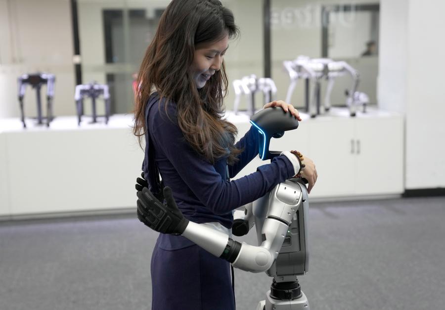 A Unitree G1 humanoid robot shows a hugging action at an exhibition hall of Unitree Robotics in Hangzhou, east China's Zhejiang Province, April 23, 2025. /Xinhua