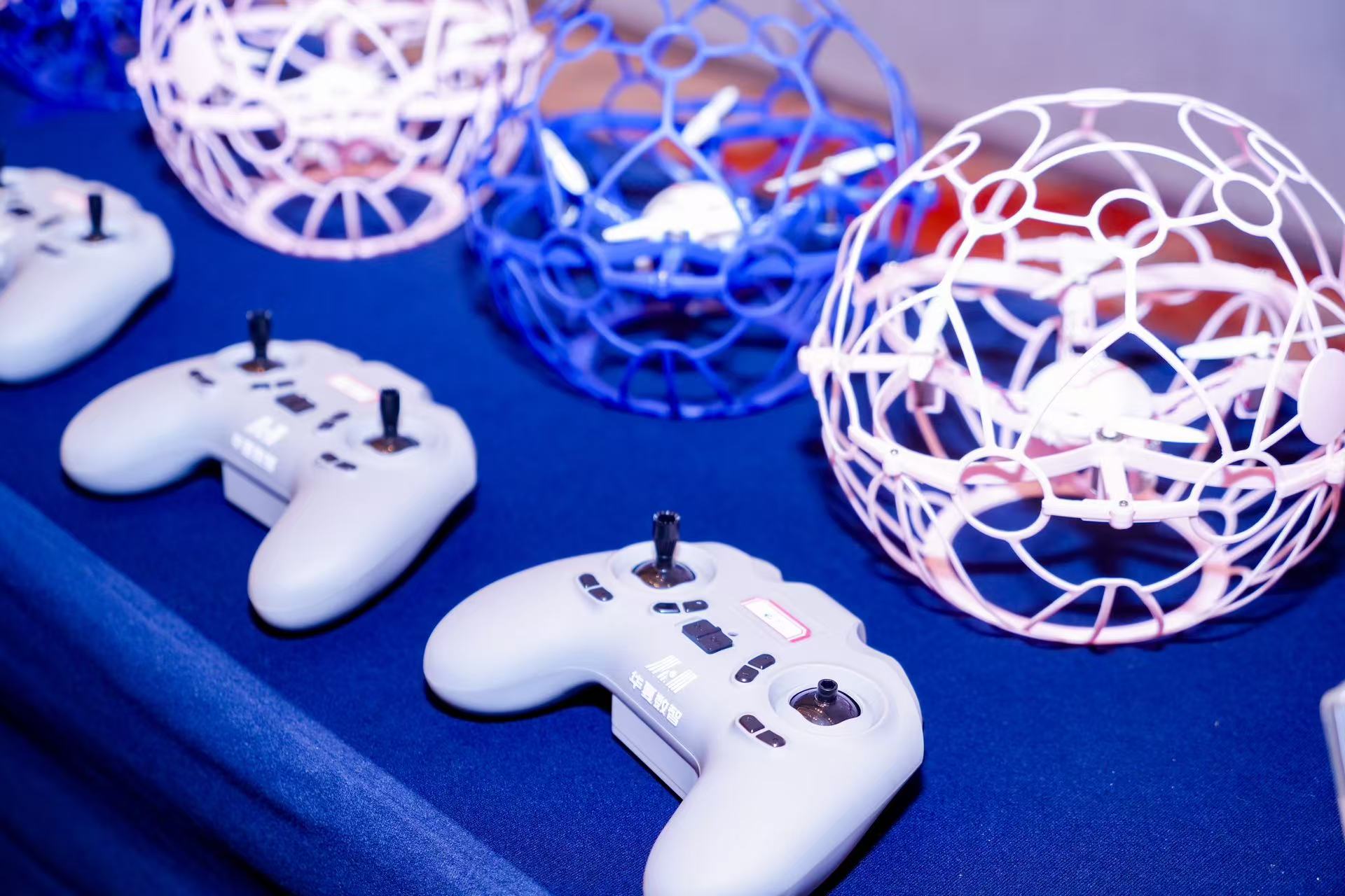 Mini soccer balls used in a drone-driven football match are showcased on the sidelines of a recently concluded conference aimed at highlighting the low-altitude economy held in Beijing on October 25, 2025. /Photo provided to CGTN