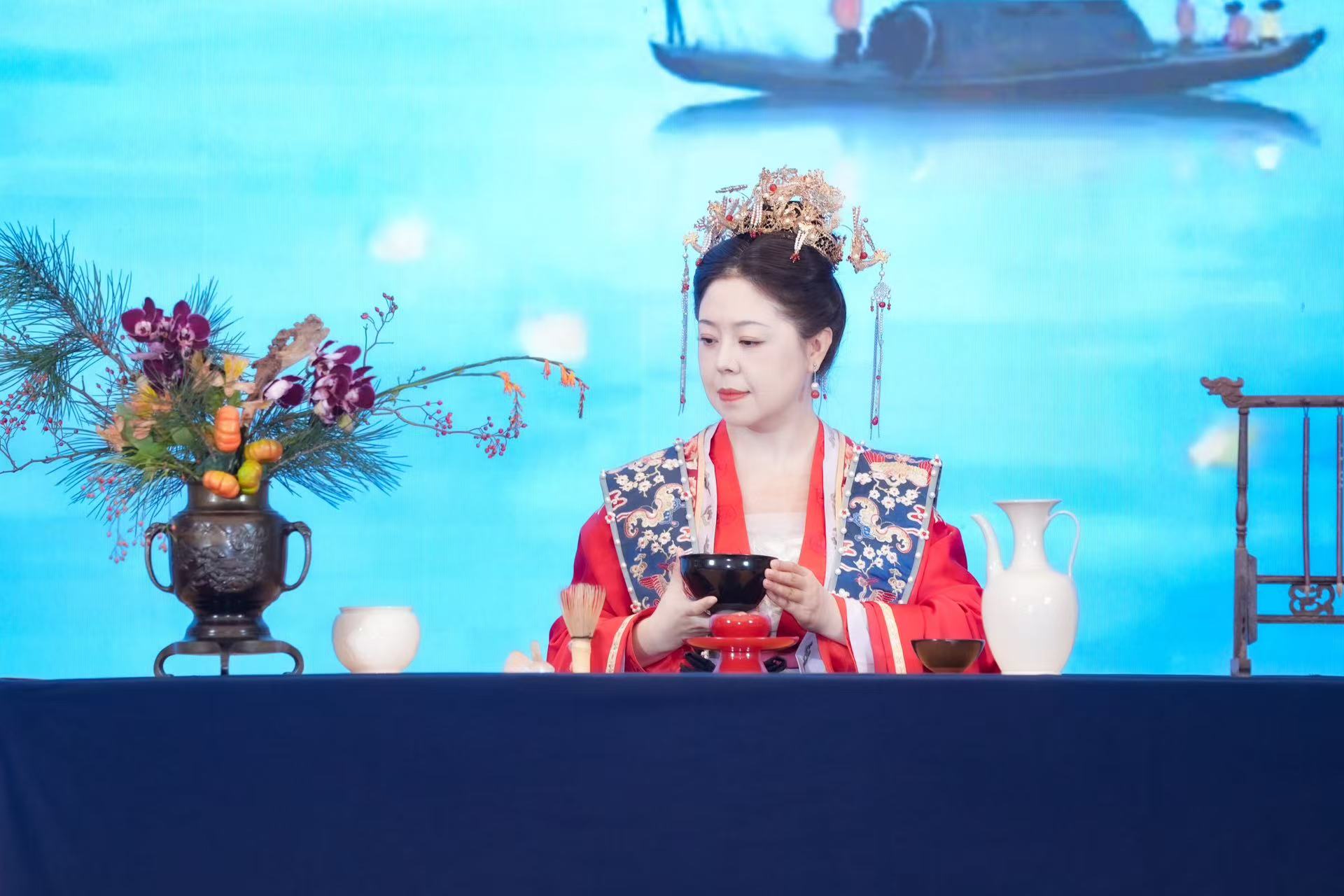 A tea art specialist and performers in ancient costumes captivate visitors at the 4th Vocational Training and Development Conference held on October 25, 2025 in Beijing's Chaoyang District. /Photo provided to CGTN