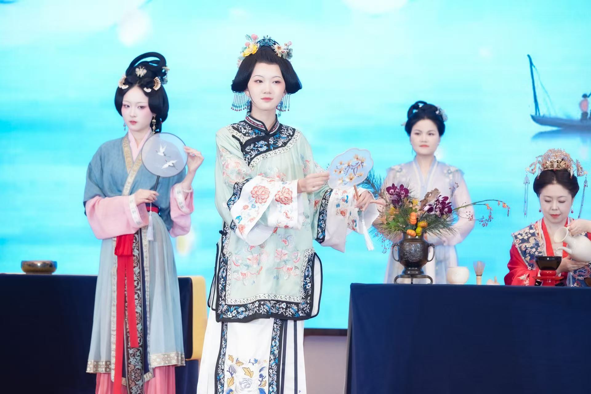 A tea art specialist and performers in ancient costumes captivate visitors at the 4th Vocational Training and Development Conference held on October 25, 2025 in Beijing's Chaoyang District. /Photo provided to CGTN