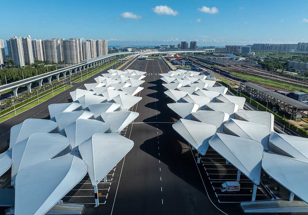 Outbound cargo trucks pass through the centralized inspection site at the 