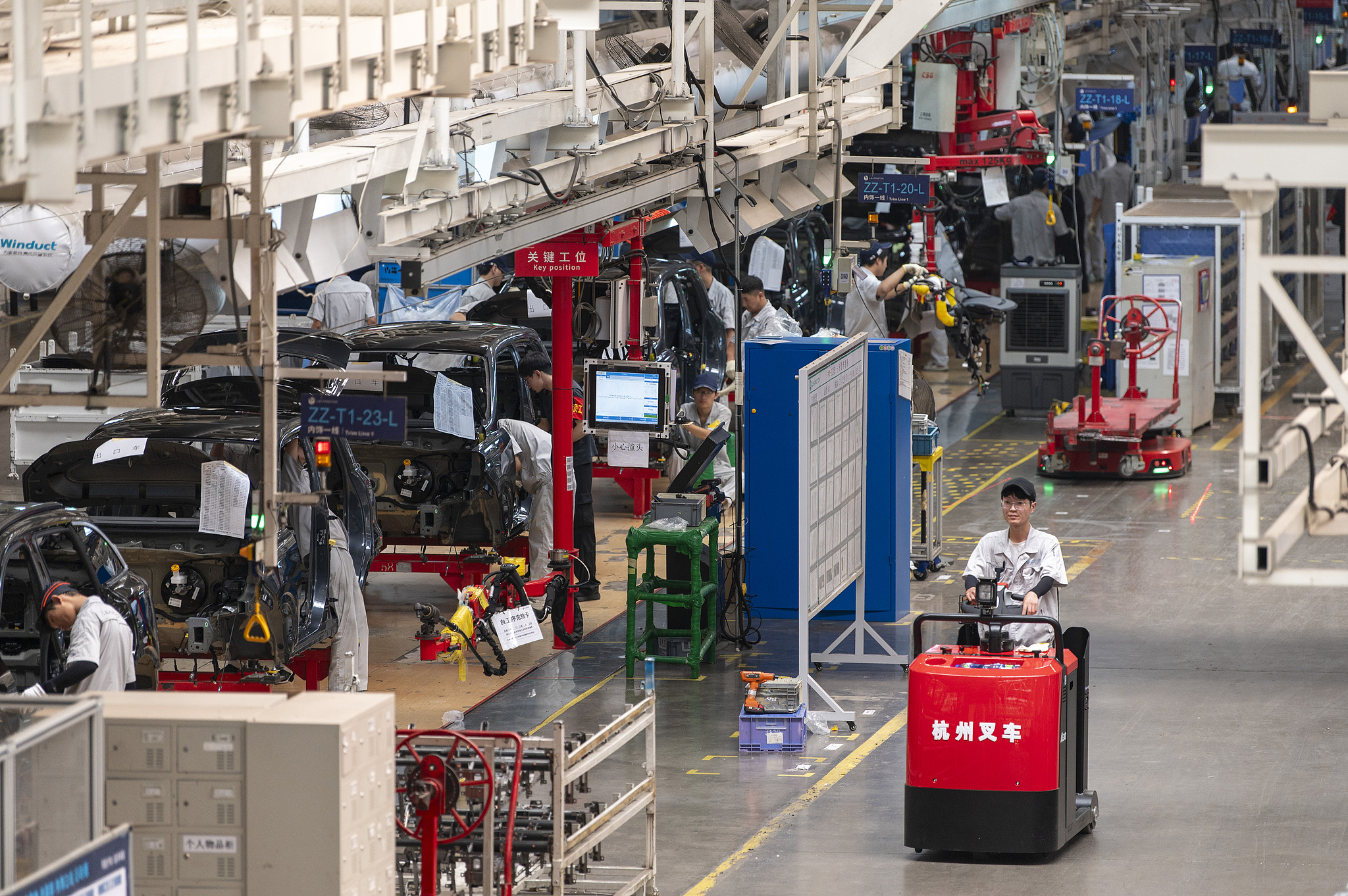 Workers seen assembling new energy vehicles at a production base in Jinhua, east China's Zhejiang Province, Oct. 12, 2025. /VCG