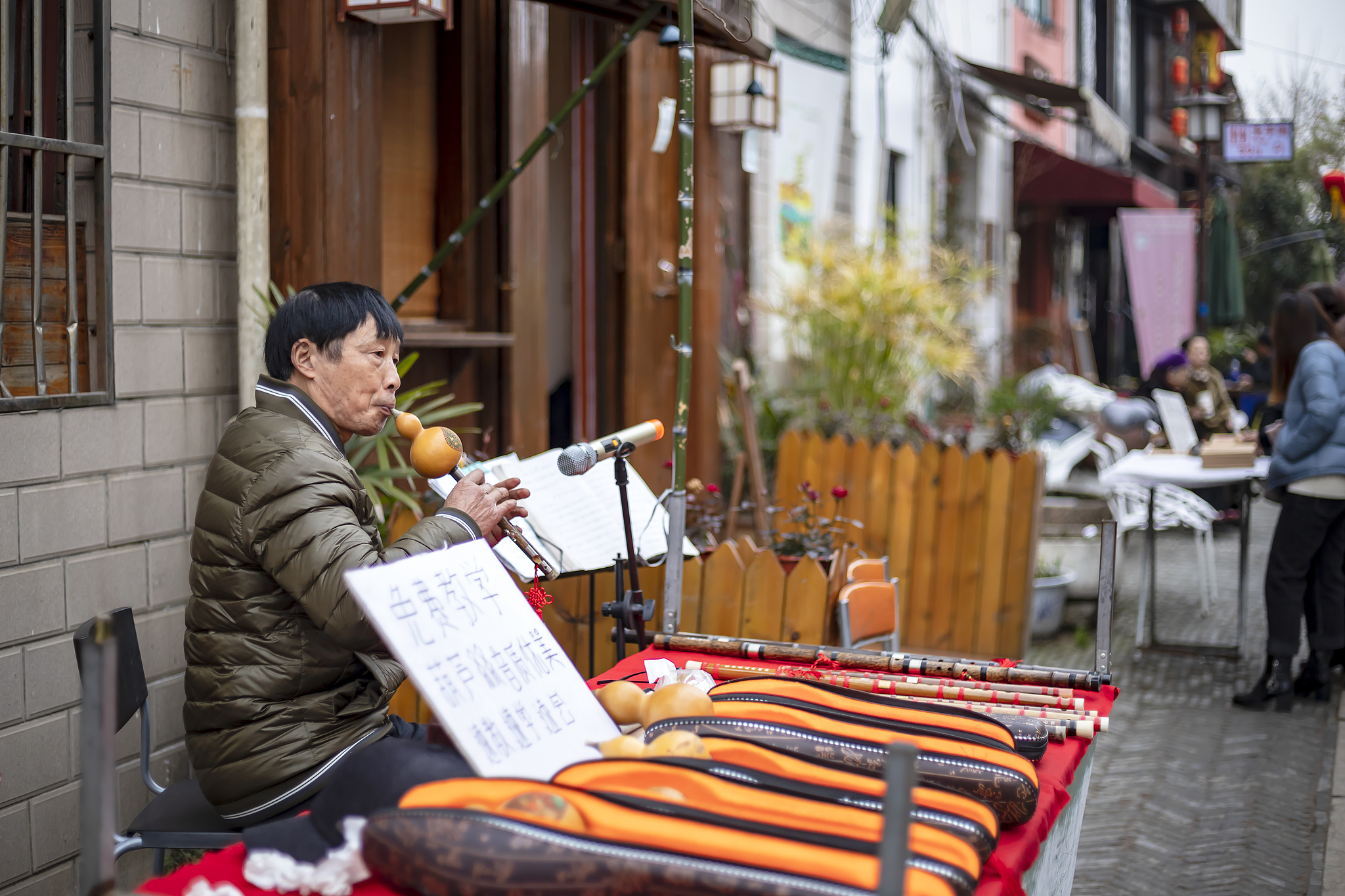 A folk musician sells the Hulusi, a free-reed wind instrument from China, on an old street in Wuxi City, east China's Jiangsu Province, February 5, 2019. /CFP