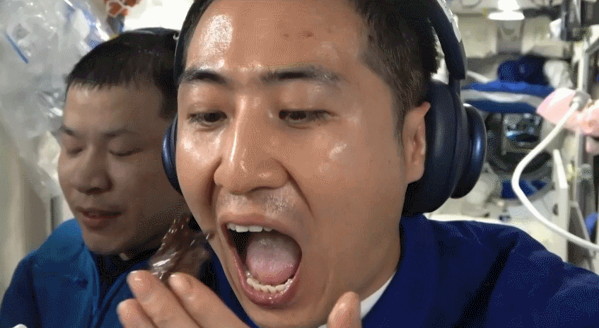 Wu Fei of the Shenzhou-21 crew eating a piece of steak inside the China Space Station. /CMG