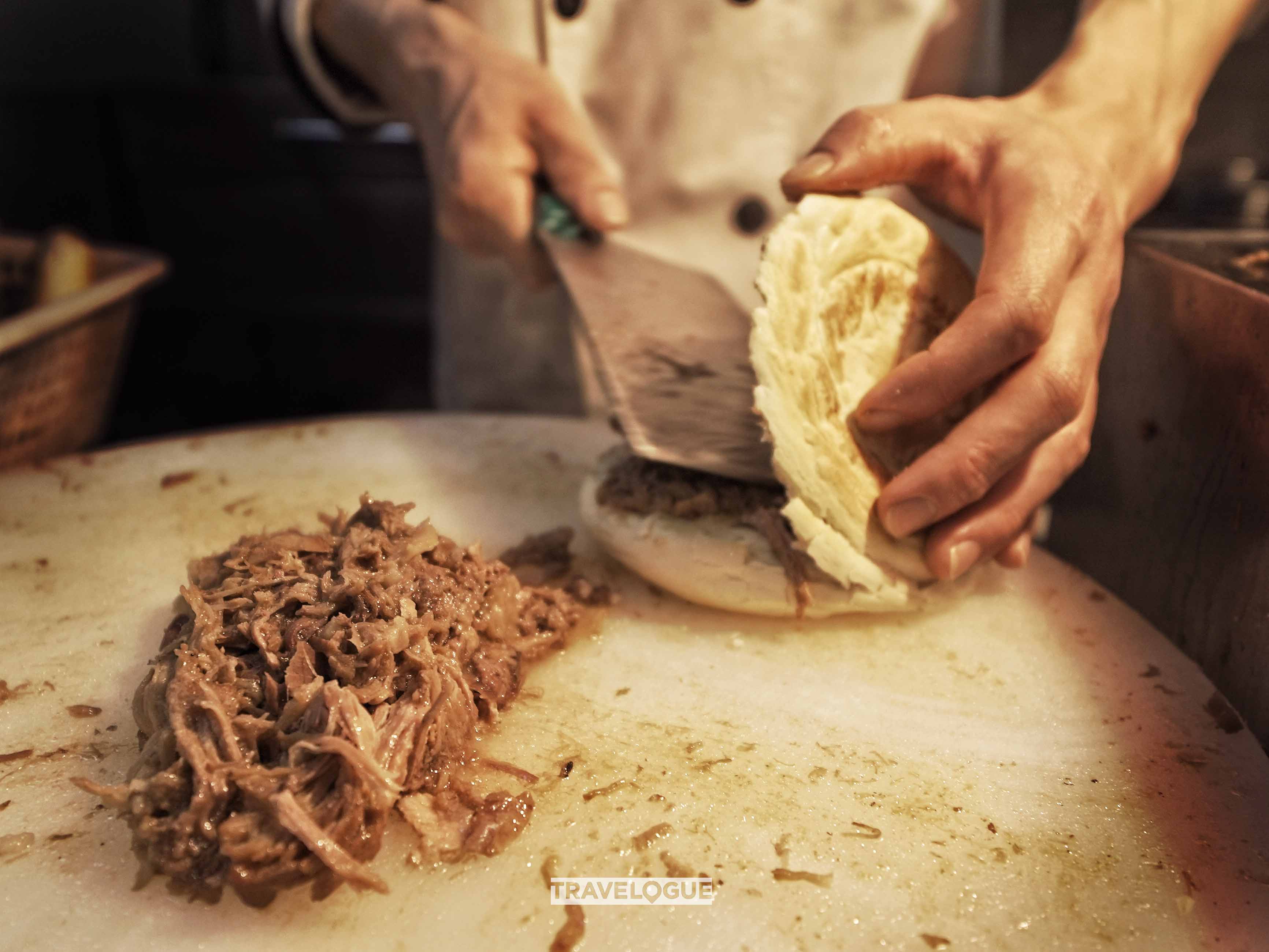 Roujiamo is a crispy “sandwich” with tender, marinated pork from Xi'an. /CGTN
