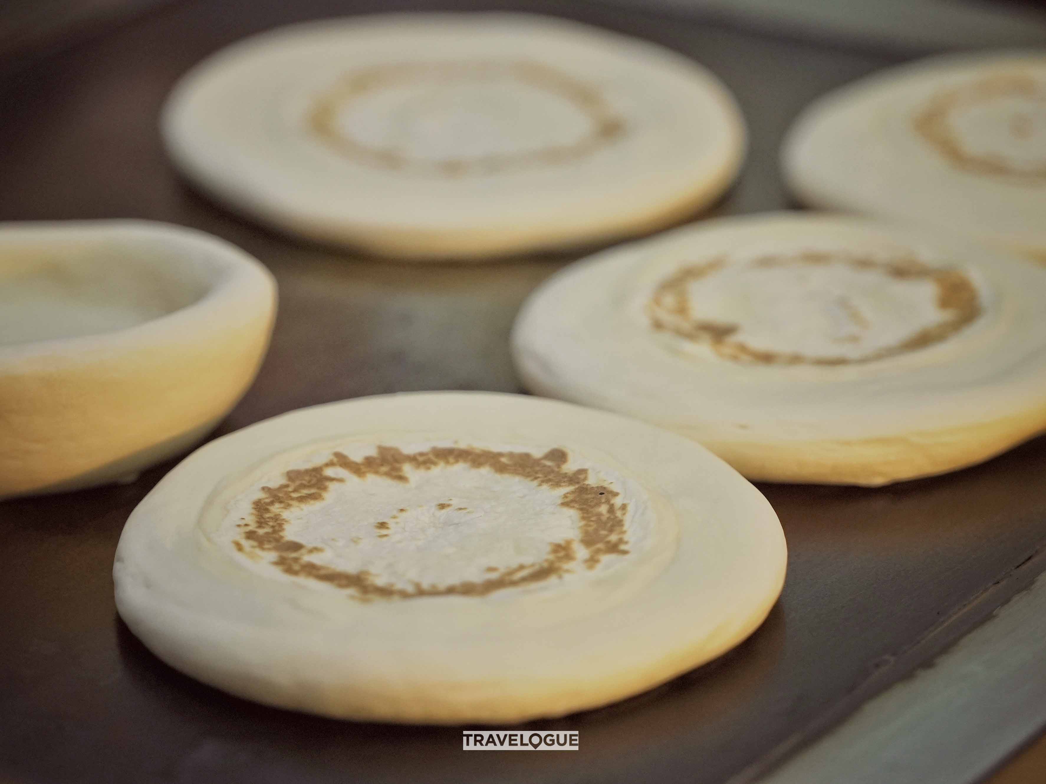 Roujiamo is a crispy “sandwich” with tender, marinated pork from Xi'an. /CGTN