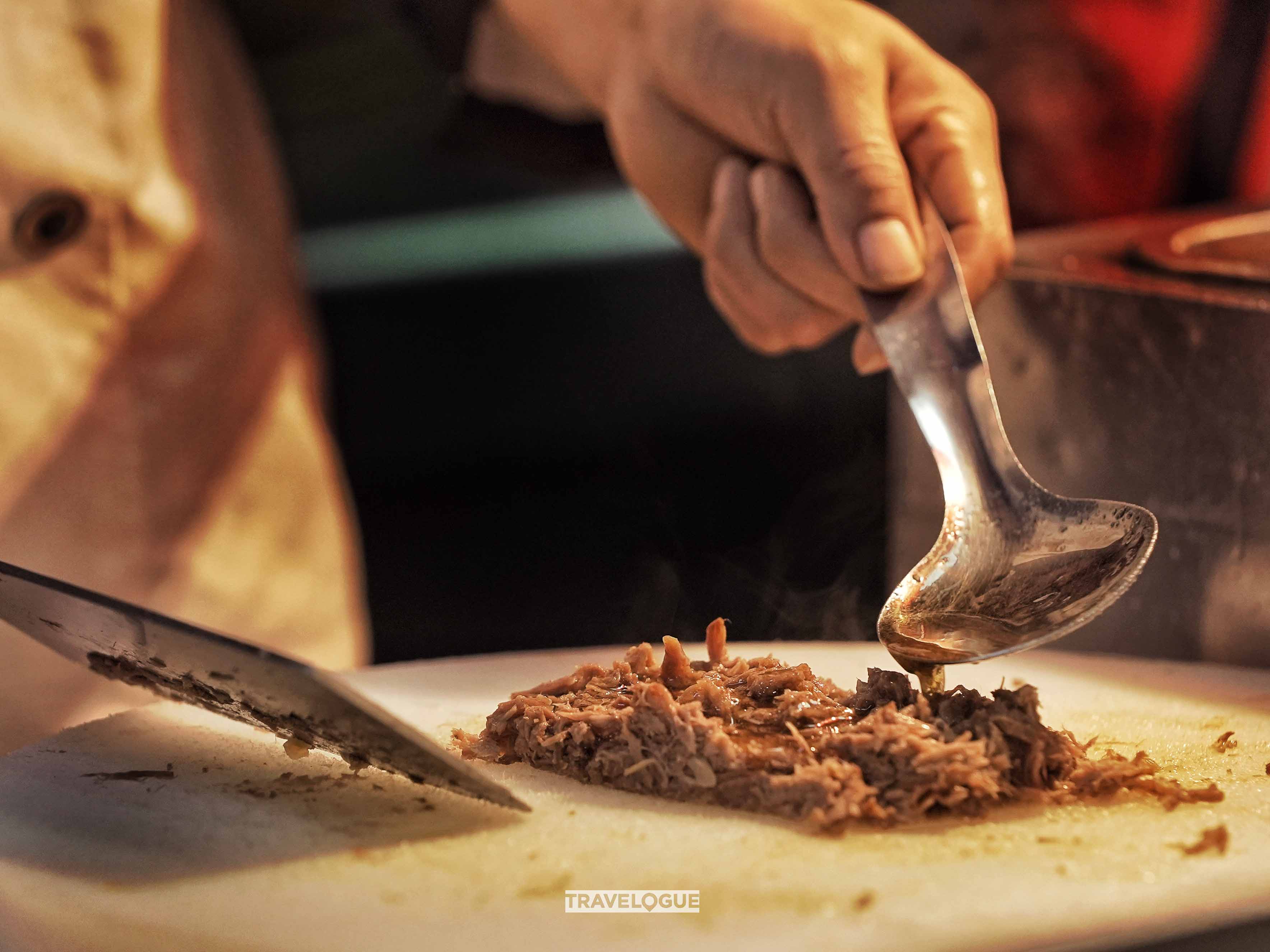 Roujiamo is a crispy “sandwich” with tender, marinated pork from Xi'an. /CGTN