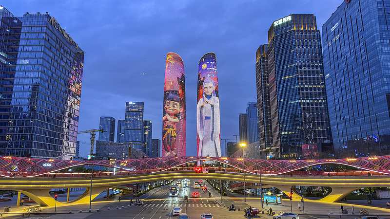 The main characters of blockbuster Chinese animation film Ne Zha 2 illuminate the skyline of Chengdu, March 15, 2025./VCG