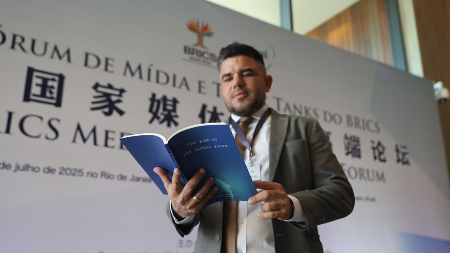 A delegate learns about a report titled The Rise of the Global South while attending the BRICS Media and Think Tank Forum in Rio de Janeiro, Brazil, July 16, 2025. /Xinhua