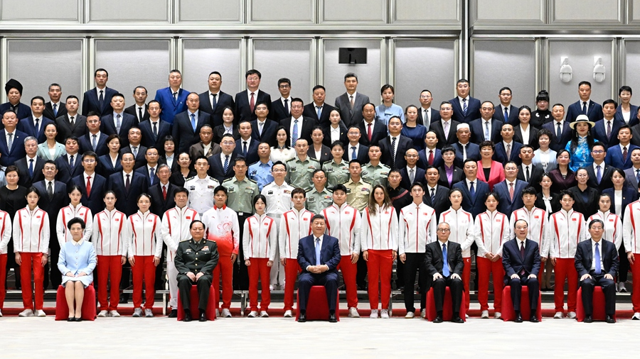 Chinese President Xi Jinping, also general secretary of the Communist Party of China Central Committee and chairman of the Central Military Commission, poses for a group photo while meeting with representatives of national model units and individuals in mass sports and competitive sports in Guangzhou, capital of south China's Guangdong Province, November 9, 2025. /Xinhua