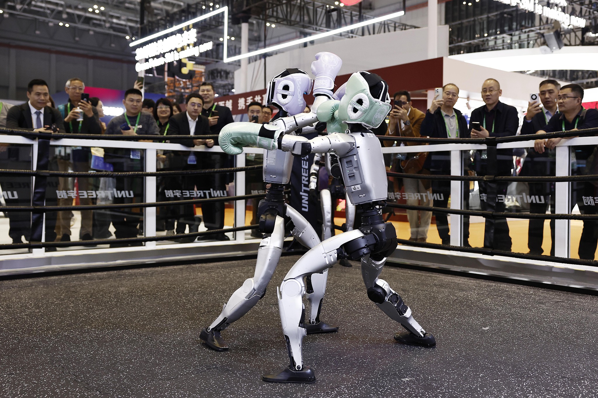 Two humanoid robots fight at civilian robotics company Unitree's booth during the China International Import Expo (CIIE) in east China's Shanghai, November 5, 2025. /VCG
