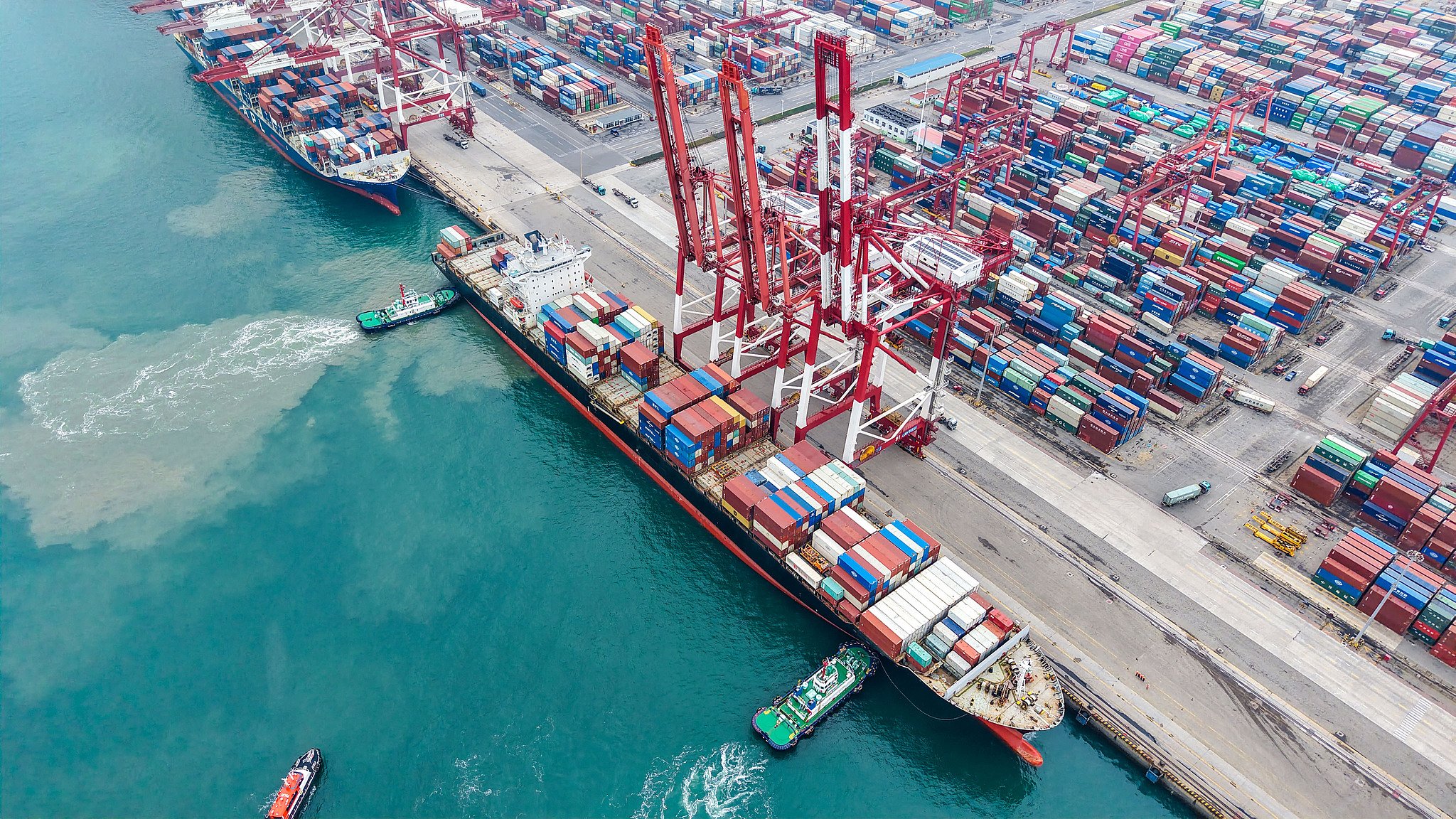 A tugboat assists a container ship in docking at a port in Qingdao, China's Shandong Province, November 8, 2025. /VCG