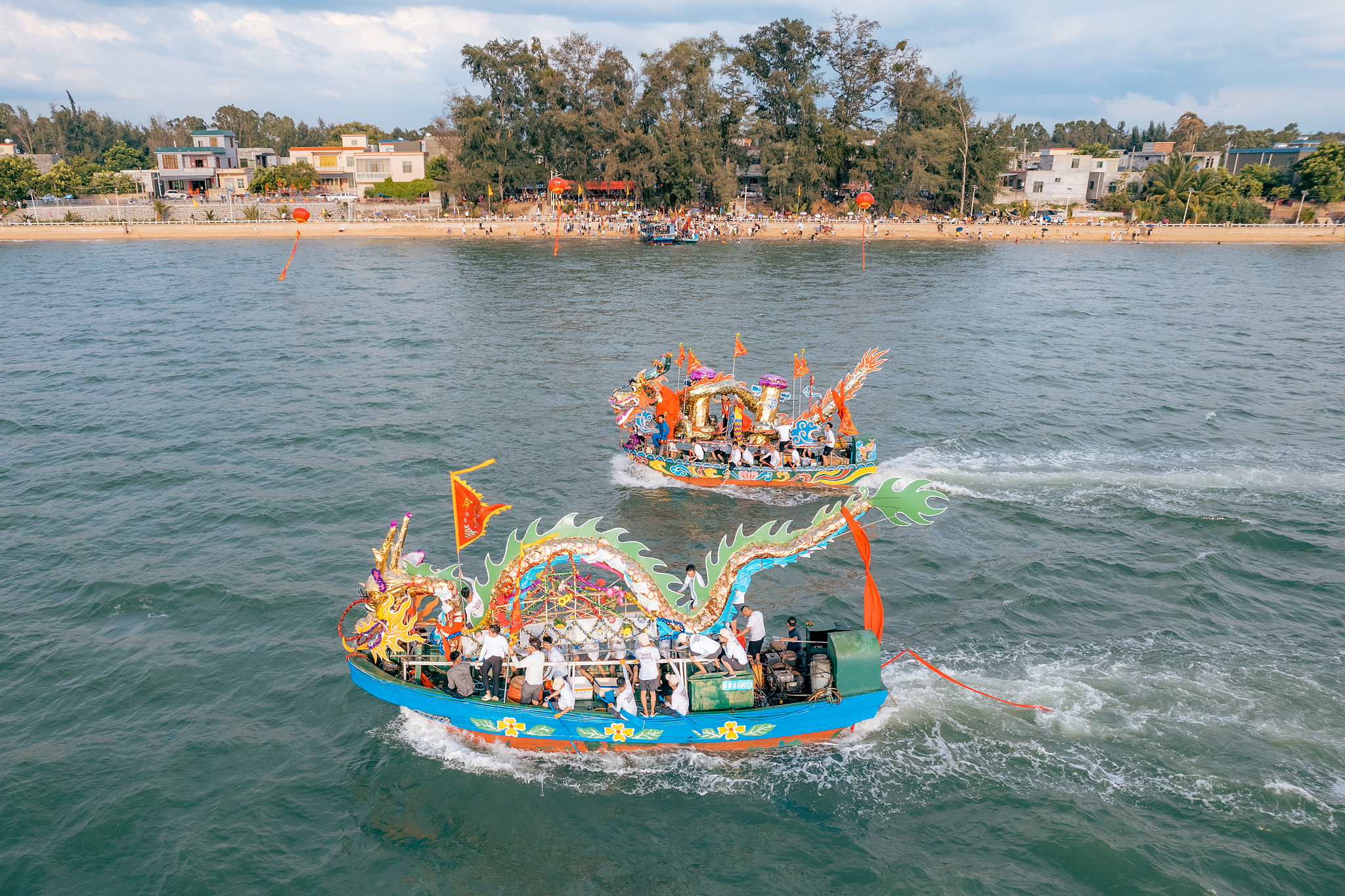 People row two dragon boats on the occasion of Dragon Boat Festival in Danzhou City, Hainan Province, China, June 22, 2023. /CFP