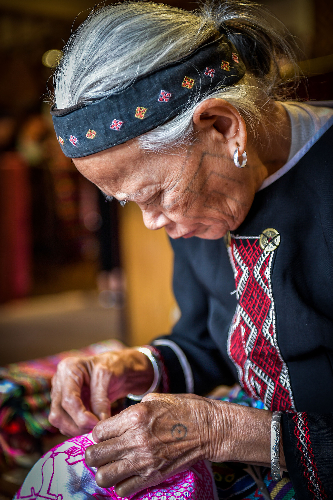 A Li woman weaves a Li embroidery work in Hainan Province, China, November 13, 2020. /CFP