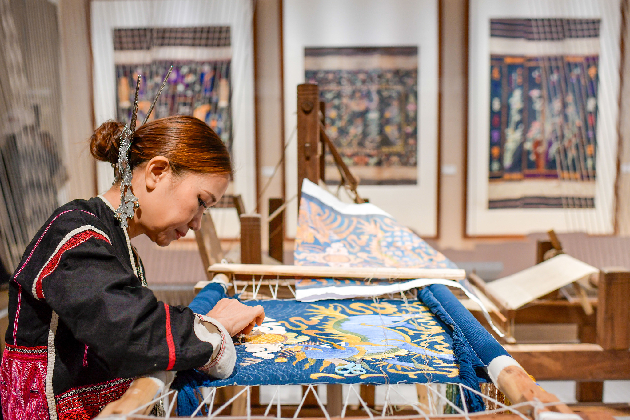 A Li woman weaves a Li embroidery work in Hainan Province, China, November 13, 2020. /CFP
