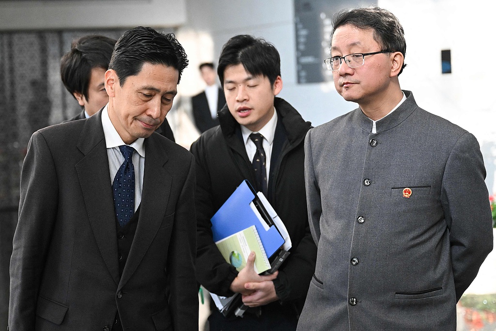 Liu Jinsong, Director General of the Department of Asian Affairs of the Chinese  Foreign Ministry, and Director-General of the Japanese Foreign Ministry's Asian and Oceanian Affairs Bureau Kanai Masaaki (L), depart after a meeting at the Chinese Foreign Ministry in Beijing on November 18, 2025.