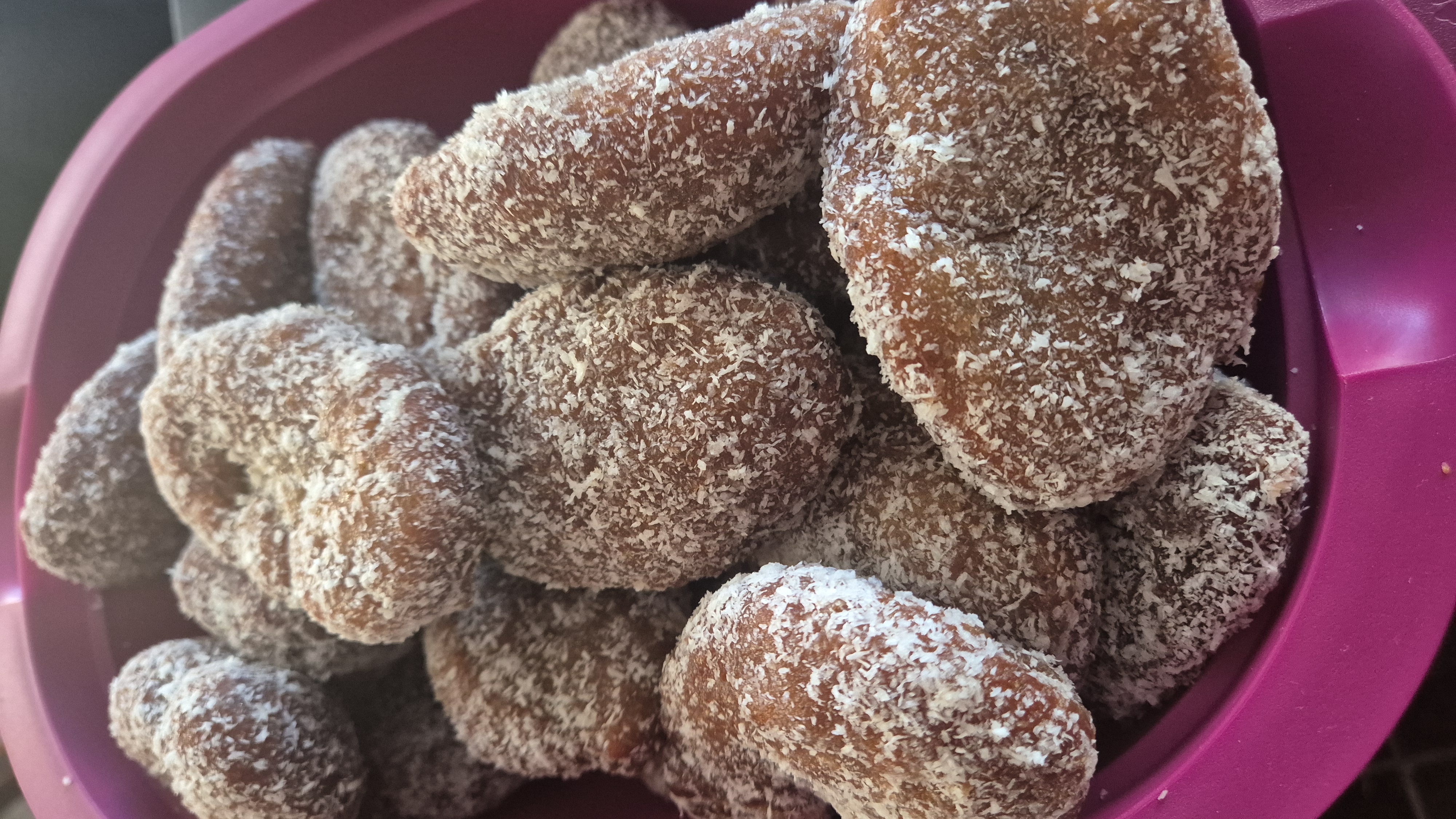 A koe'sister is a deep-fried spiced dough ball, dipped in syrup and rolled in desiccated coconut. This is a variation of the traditional koeksister. /Shanaaz Prince