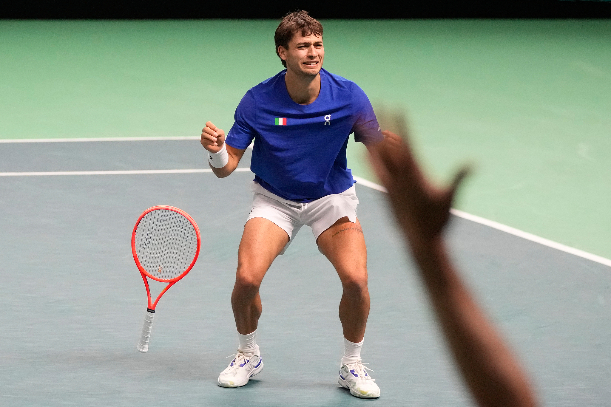 Flavio Cobolli of Italy celebrates after defeating Zizou Bergs of Belgium 6-3, 6-7 (5), 7-6 (15) in the semifinal match at the Davis Cup in Bologna, Italy, November 21, 2025. /VCG