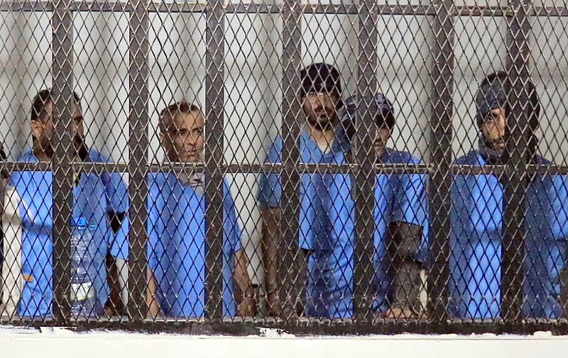 Defendants stand behind bars during a sentencing hearing at the state security court in Sanaa, Yemen, on November 22, 2025. /VCG