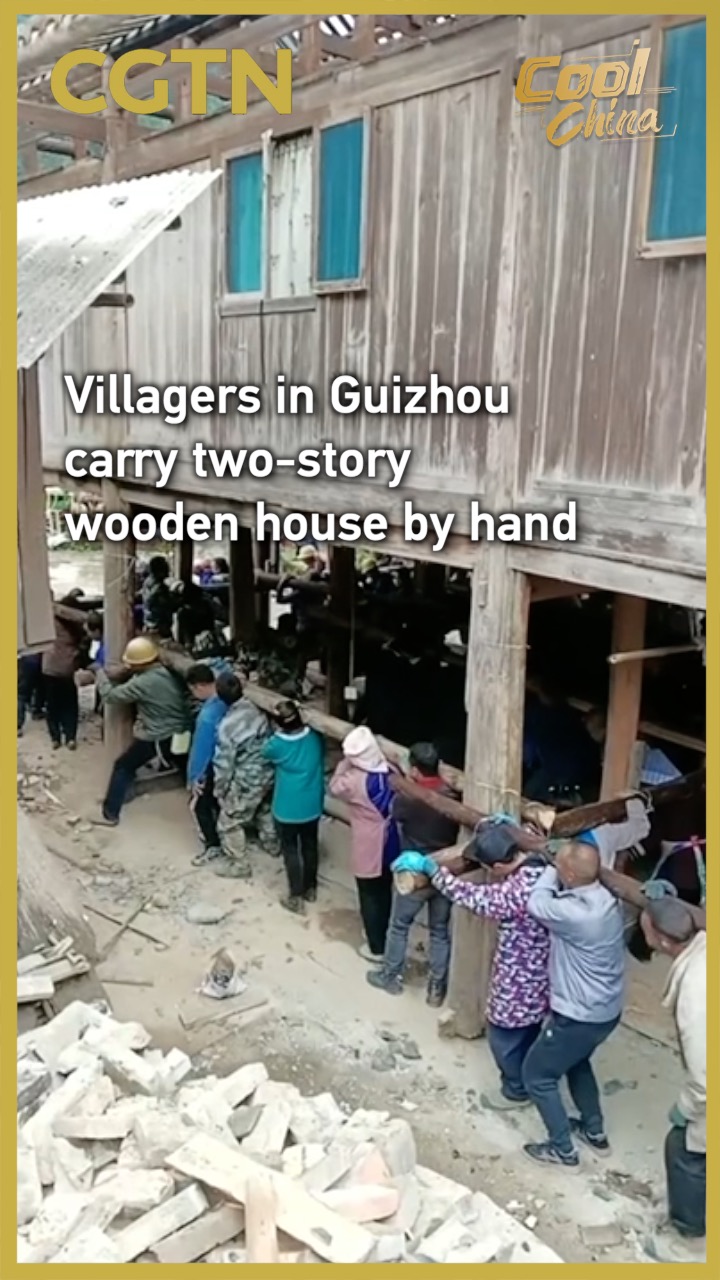 Villagers in Guizhou carry two-story wooden house by hand