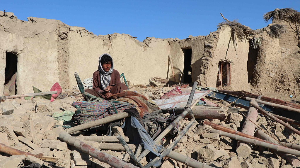 A resident sits at a damaged house after an airstrike by Pakistan in Jige Mughalgai, Khost province, November 25, 2025. /VCG