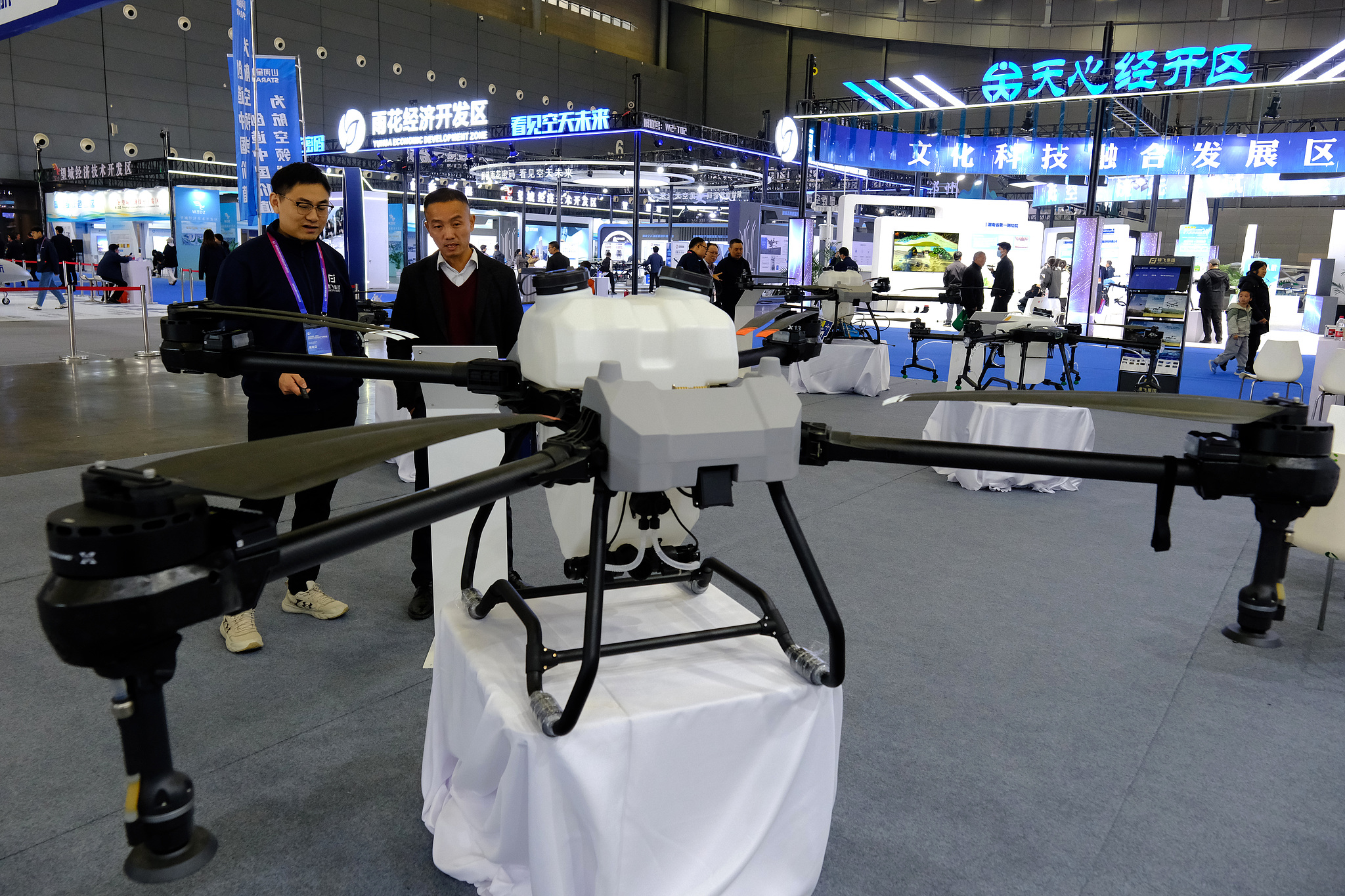 Visitors seen examining agricultural plant protection drones at the 2025 Hunan International General Aviation and Low-altitude Economy Industry Expo, November 22, 2025, in Changsha, China's Hunan Province. /VCG