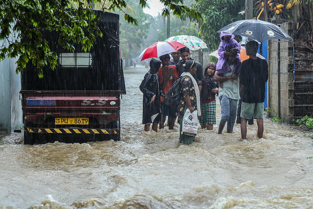 Residents wade through a flooded street in Puttalam, Sri Lanka, November 27, 2025. /CFP