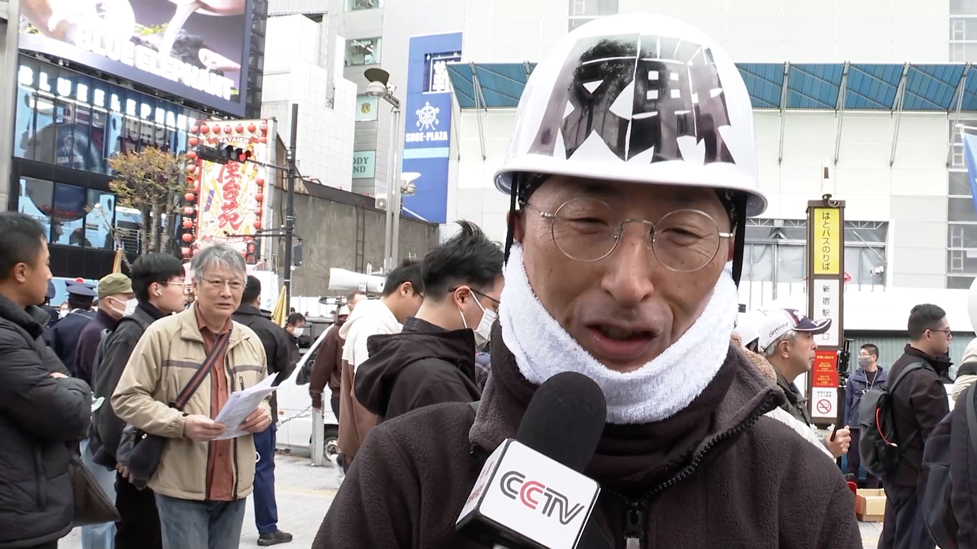 A protester taking part in the demonstration in Tokyo's Shinjuku District speaks to CMG during an interview, November 29, 2025. /CMG