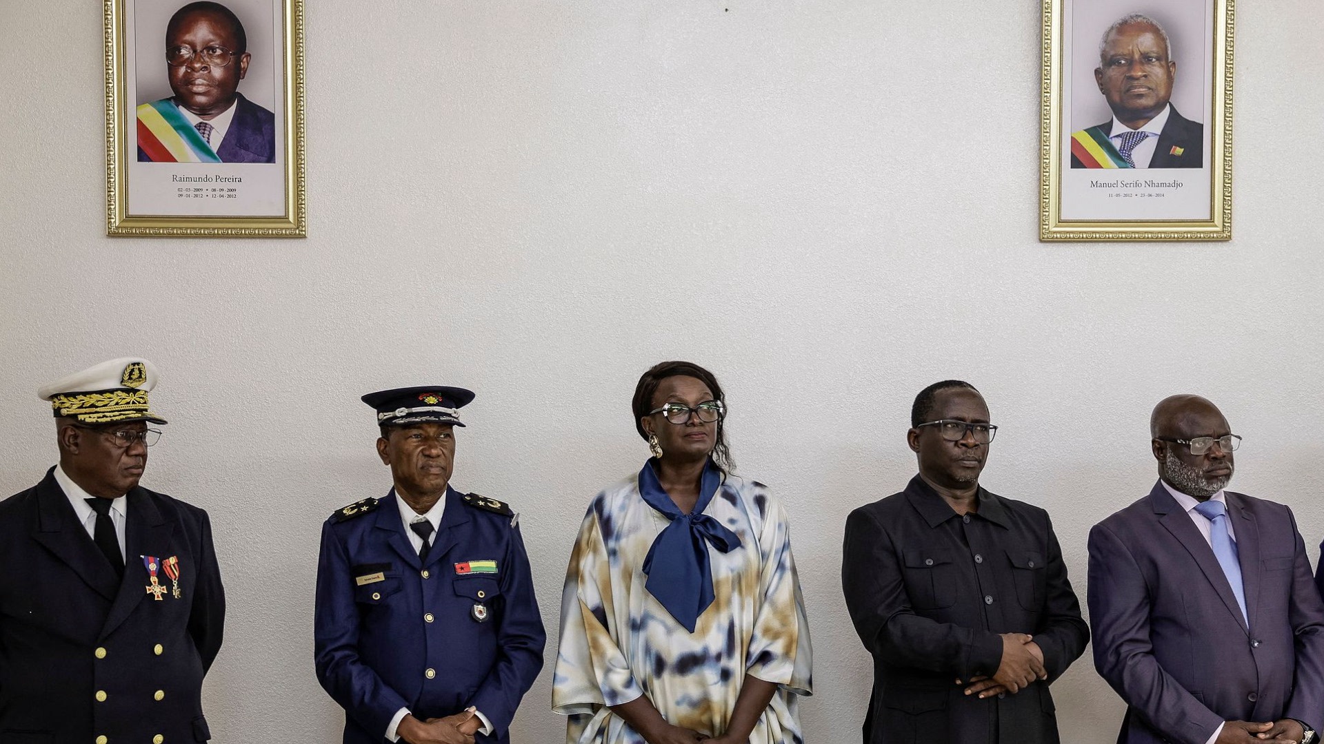 Newly elected members of the Guinea-Bissau transitional government stand under portraits of former presidents Raimundo Pereira (L) and Manuel Serifo Nhamadjo (R) during a swearing-in ceremony at the Presidential Palace in Bissau on November 29, 2025. /VCG
