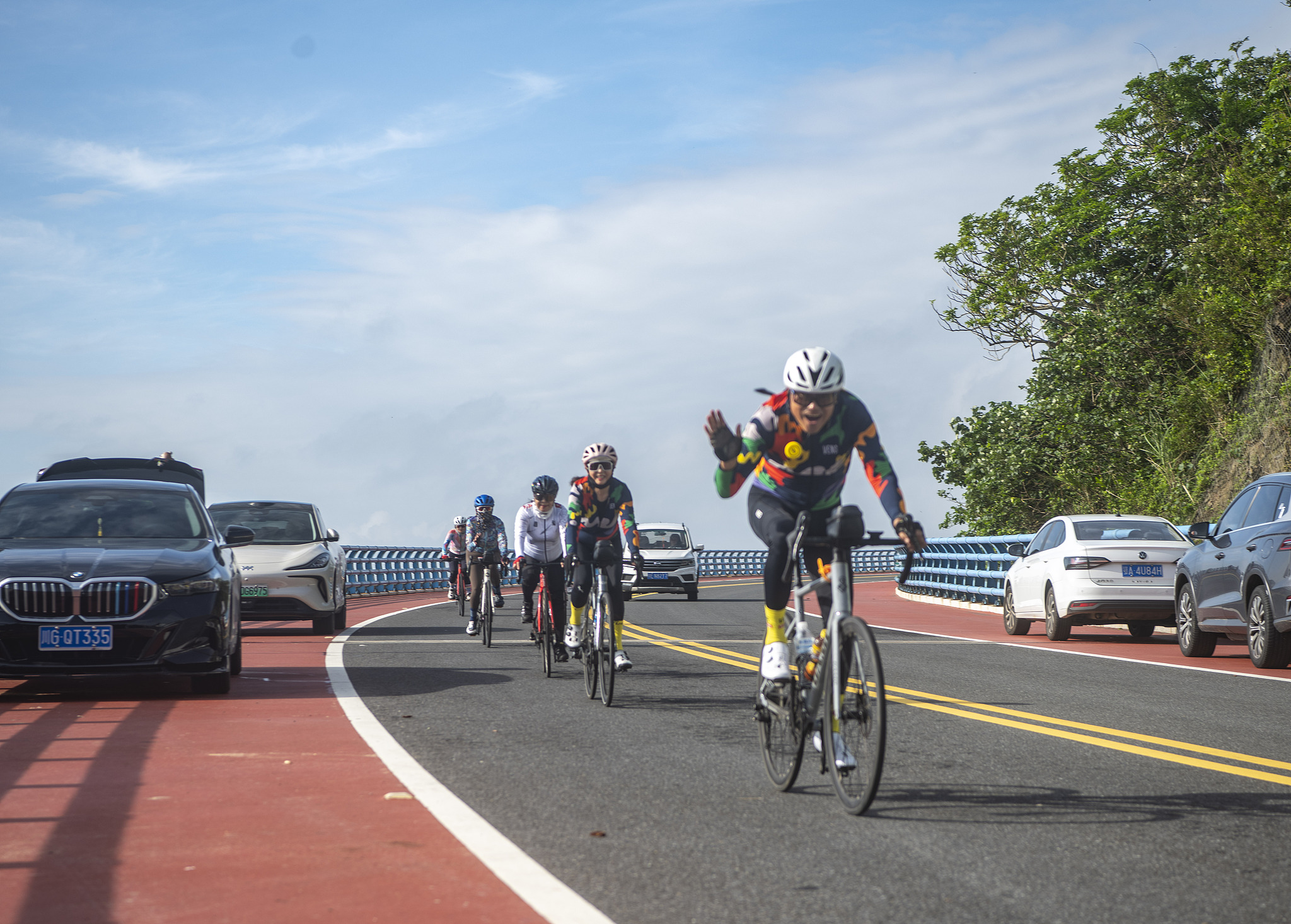 Tourists cycling on a scenic highway overpass in South China's Hainan Province, November 9, 2025. /VCG