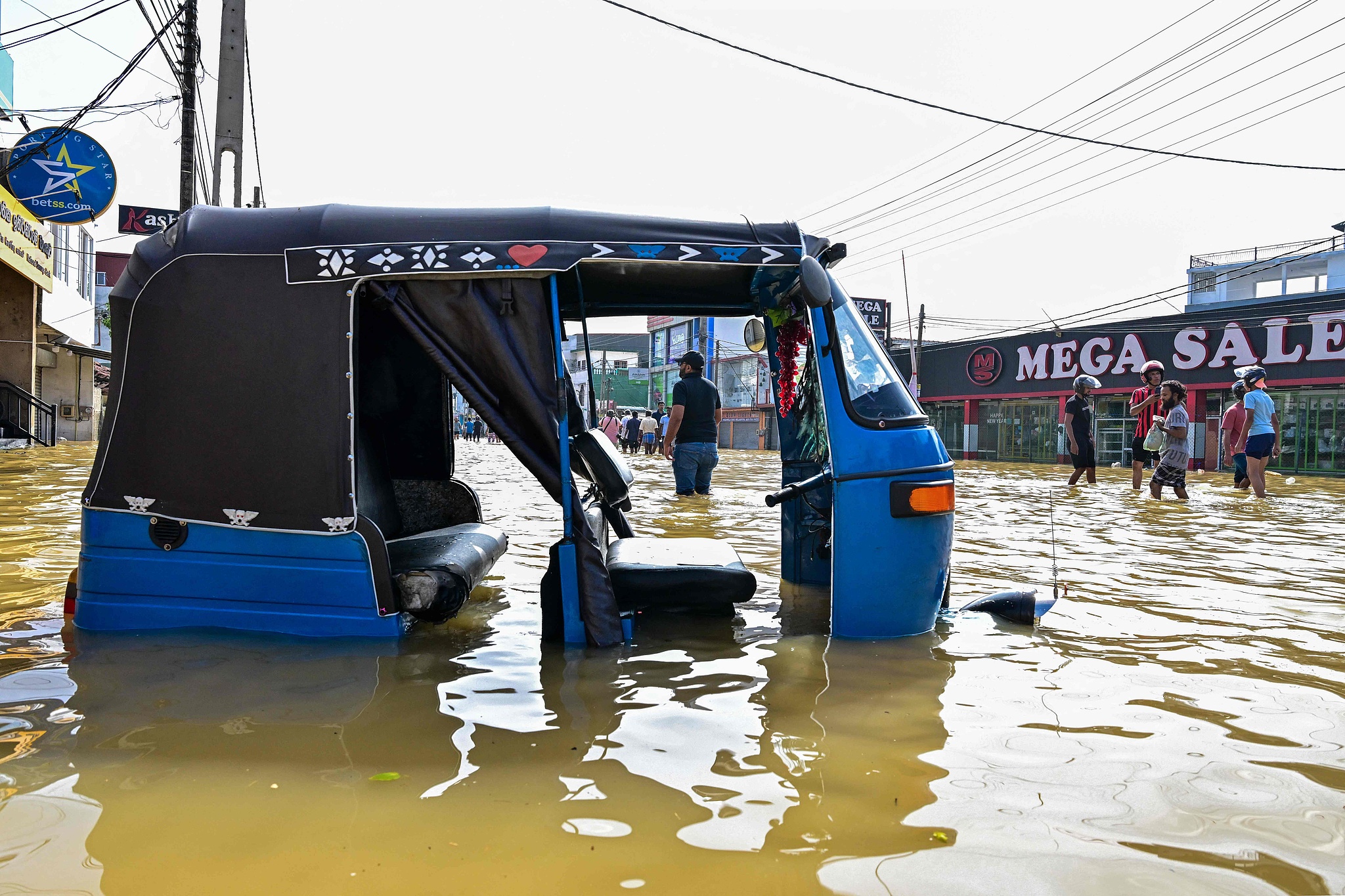 An auto rickshaw lies stranded after heavy rainfall in Wellampitiya on the outskirts of Colombo, Sri Lanka, November 30, 2025. /VCG