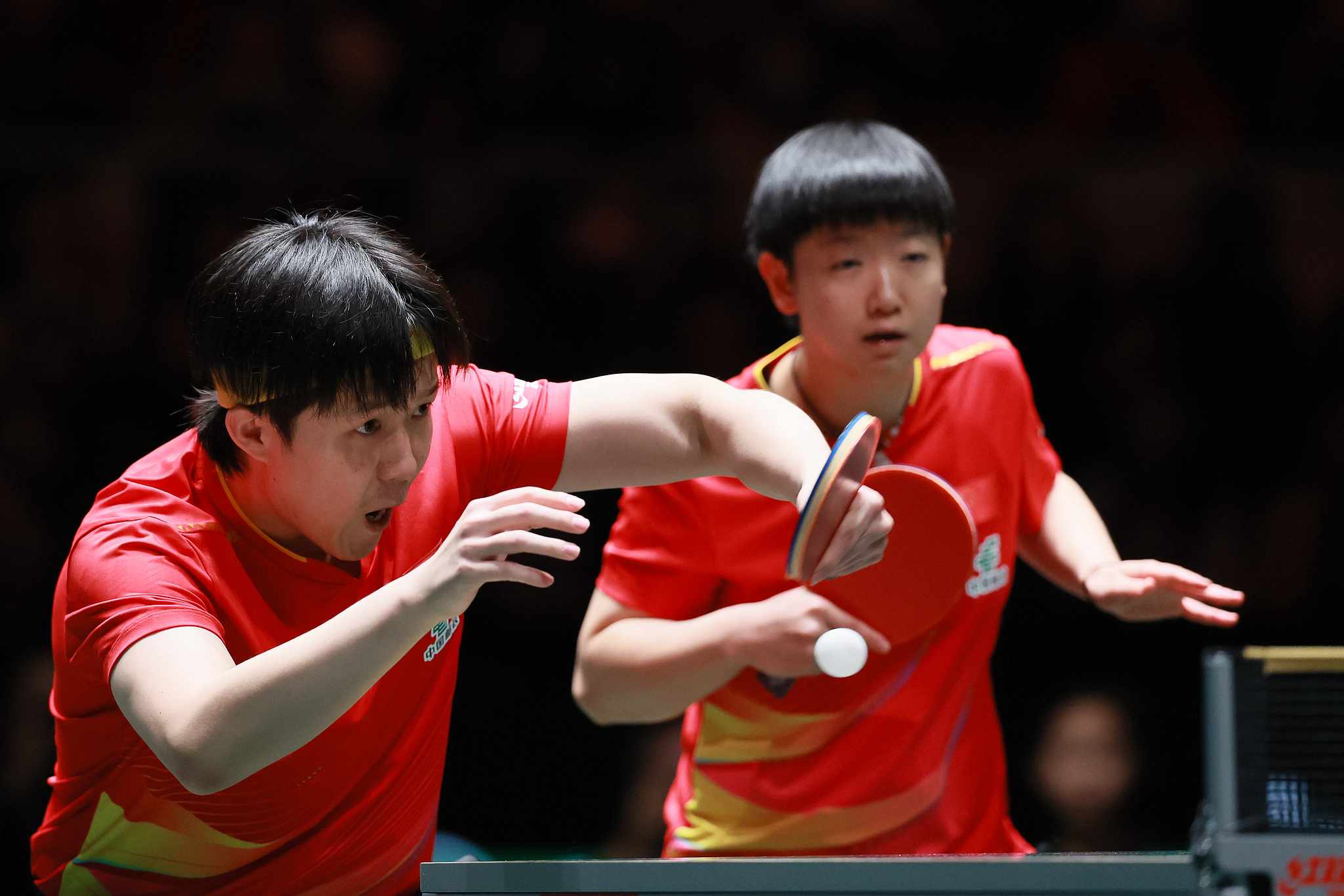 Wang Chuqin (L) of China hits a shot as partner Sun Yingsha looks on in a mixed doubles match against Alexis Lebrun and Jia Nan Yuan of France at the ITTF (International Table Tennis Federation) Mixed Team World Cup in Chengdu, southwest China's Sichuan Province, December 4, 2025. /VCG