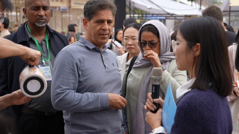 Reza Pirpiran (second from left) observes the barista demonstrations during the event.