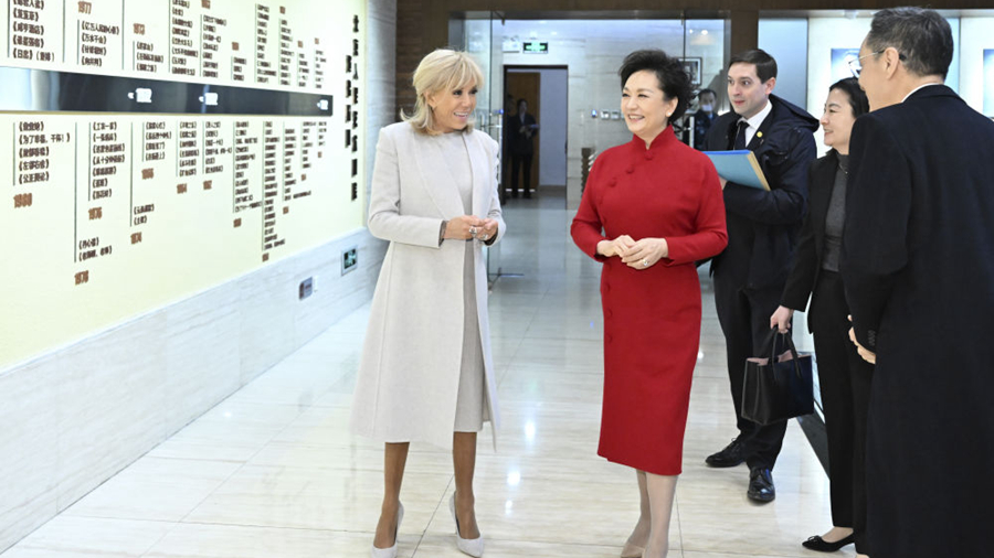 Peng Liyuan, wife of Chinese President Xi Jinping, and Brigitte Macron, wife of French President Emmanuel Macron, visit the Beijing People's Art Theatre in Beijing, China, December 4, 2025. /VCG