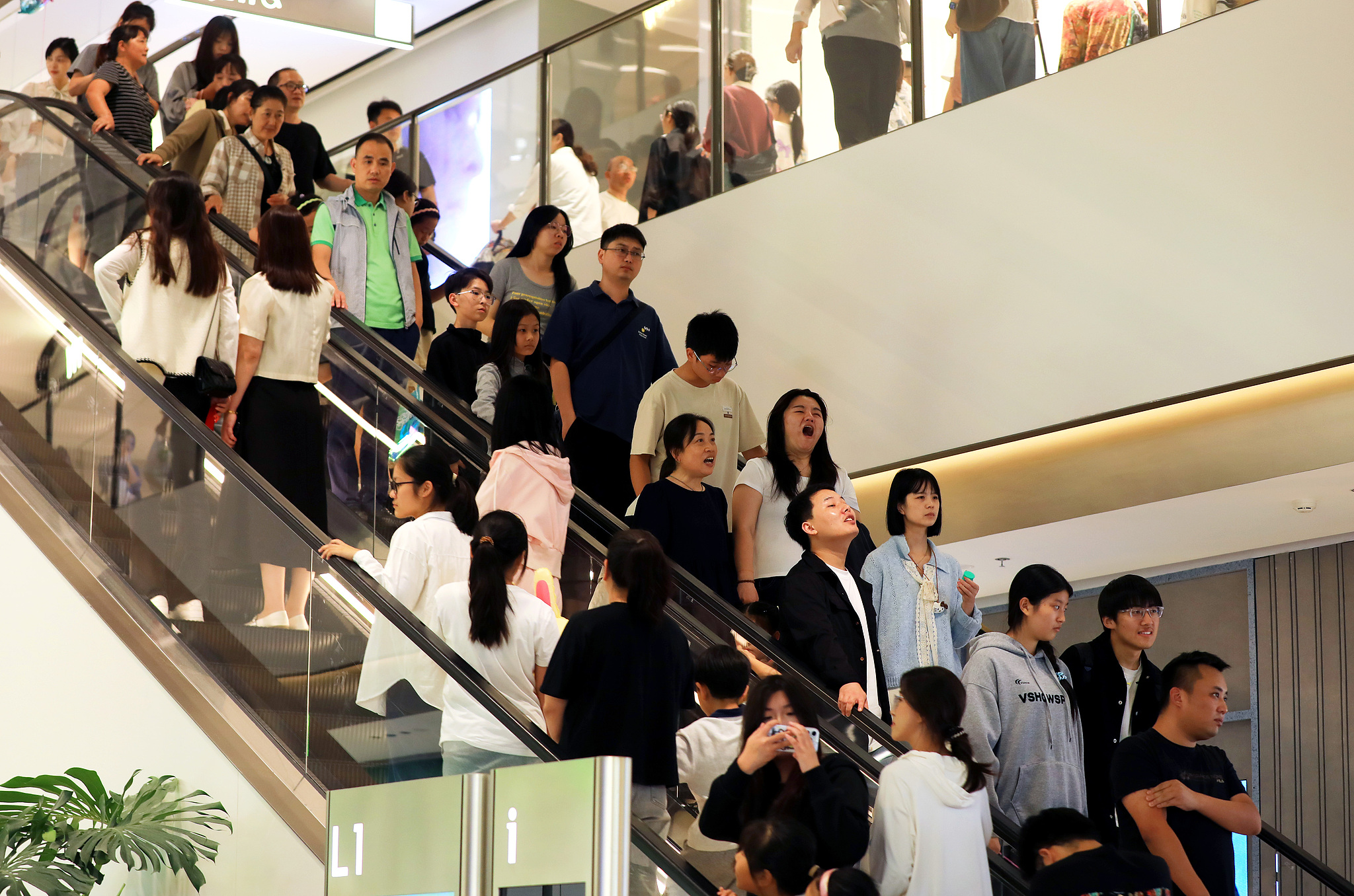 The newly opened Mixc mall in Huai'an, Jiangsu Province, is packed with visitors as residents stroll through the shops, enjoying shopping, and celebrating the National Day holiday on October 1, 2025. /VCG