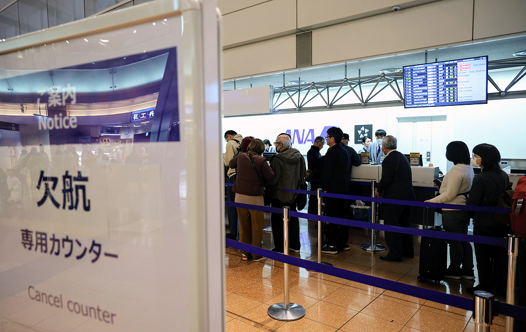 People line up at a cancellation counter at Haneda Airport in Tokyo, Japan on November 29, 2025. /VCG