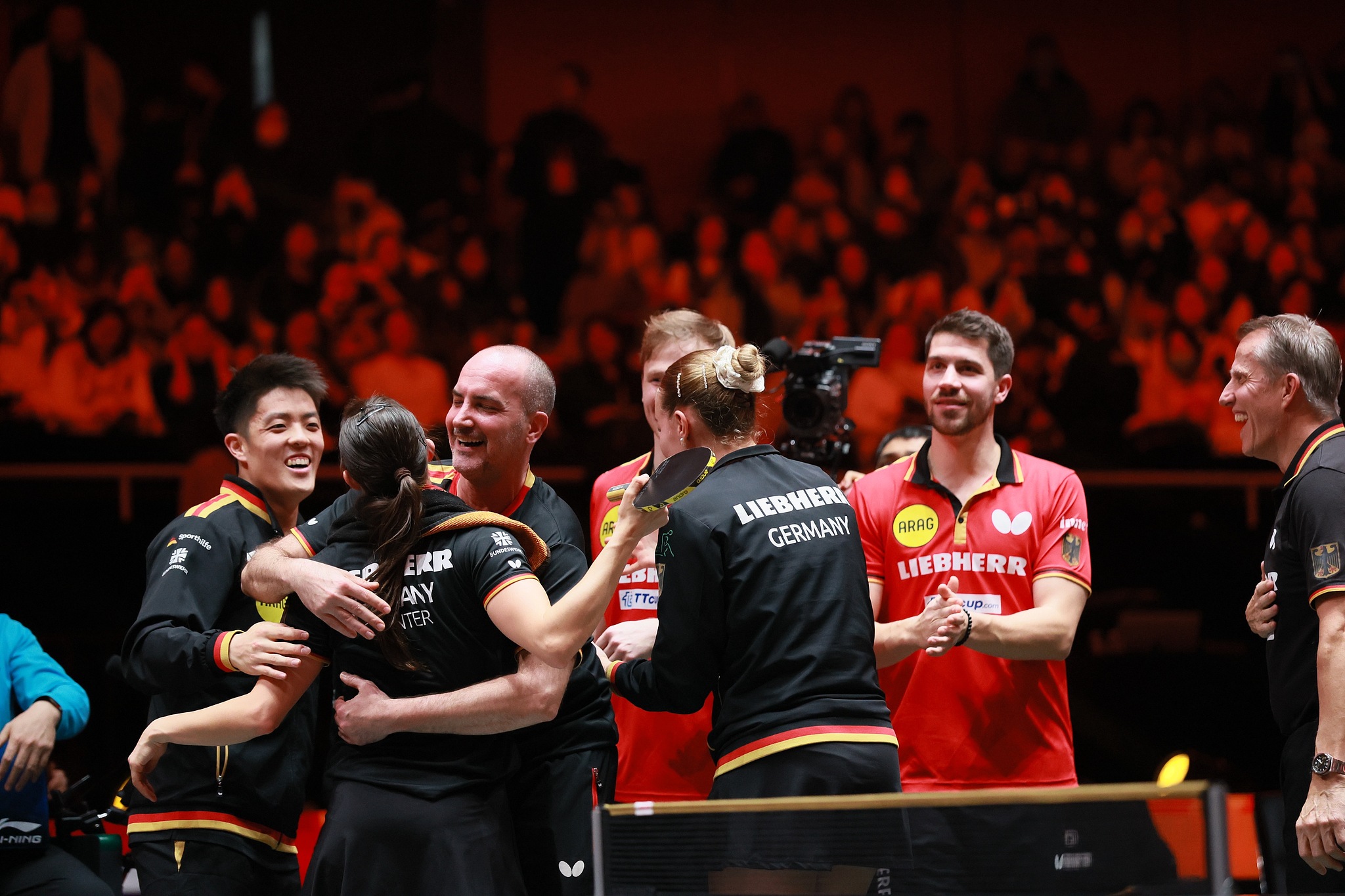 Germany's table tennis players and coaches celebrate after beating the Republic of Korea to clinch third place at the ITTF Mixed Team World Cup in Chengdu, China, December 7, 2025. /VCG