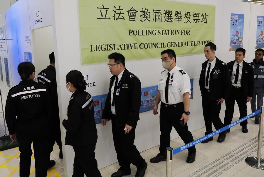 Voters arrive at a polling station at Hong Kong International Airport in Hong Kong, south China, December 7, 2025. /Xinhua