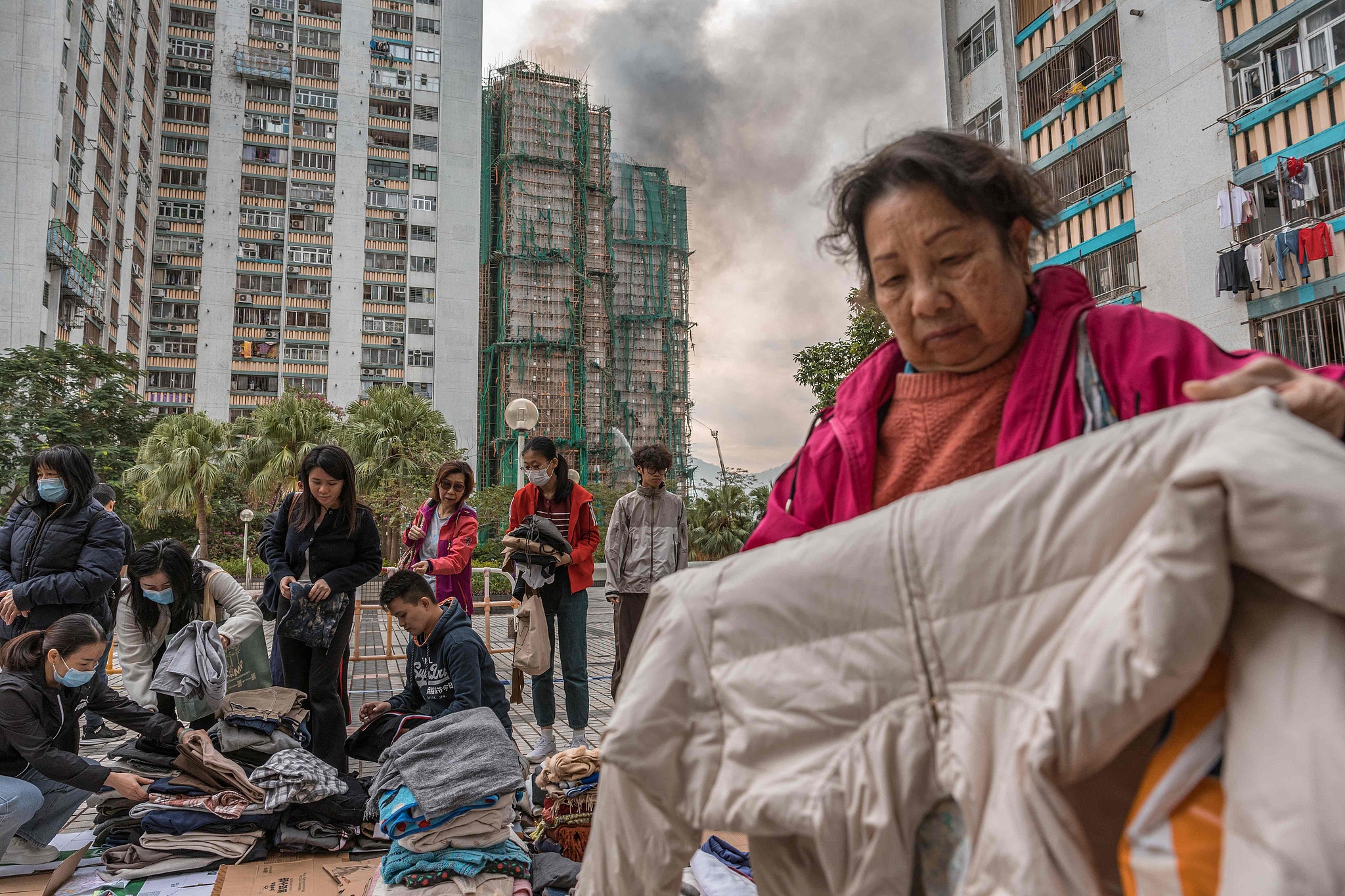 Residents check clothing donated to them after a major fire swept through apartment blocks at the Wang Fuk Court residential estate in Hong Kong's Tai Po district on November 27, 2025. /CFP